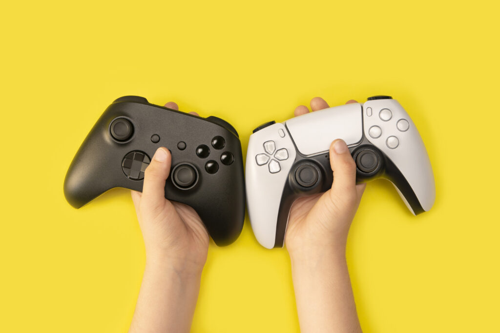 kid-holding-game-controllers-yellow-background